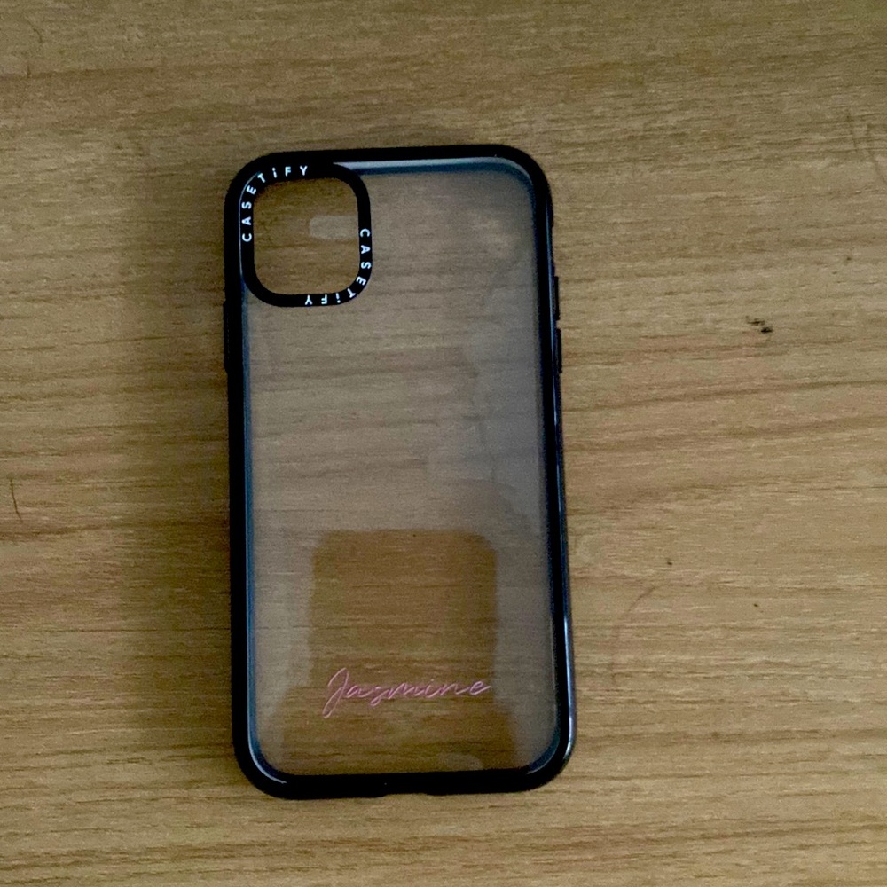 clear case with the name Jasmine in hot pink embroidered